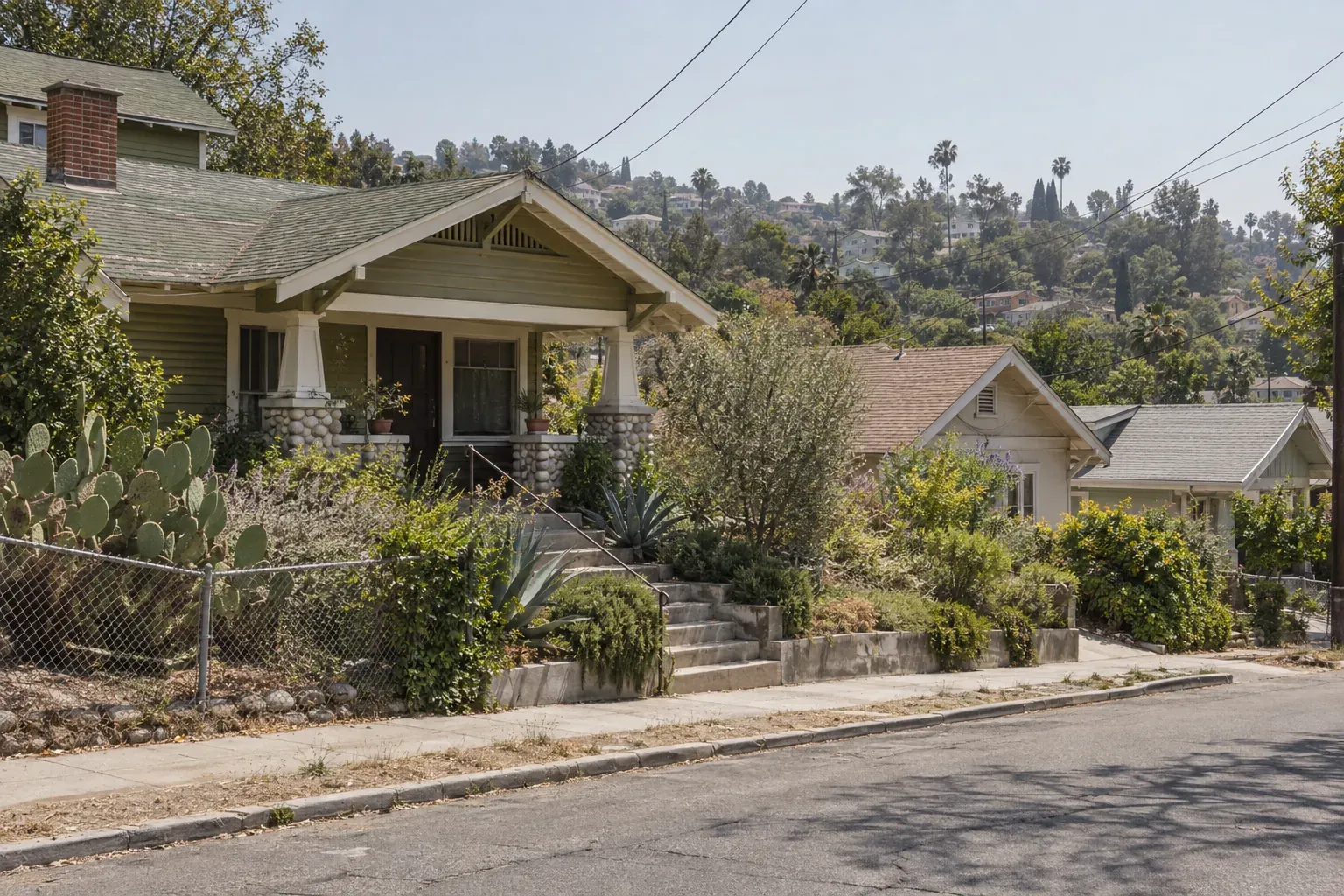 Craftsman homes with shingle roofs on a hillside, typical of Highland Park